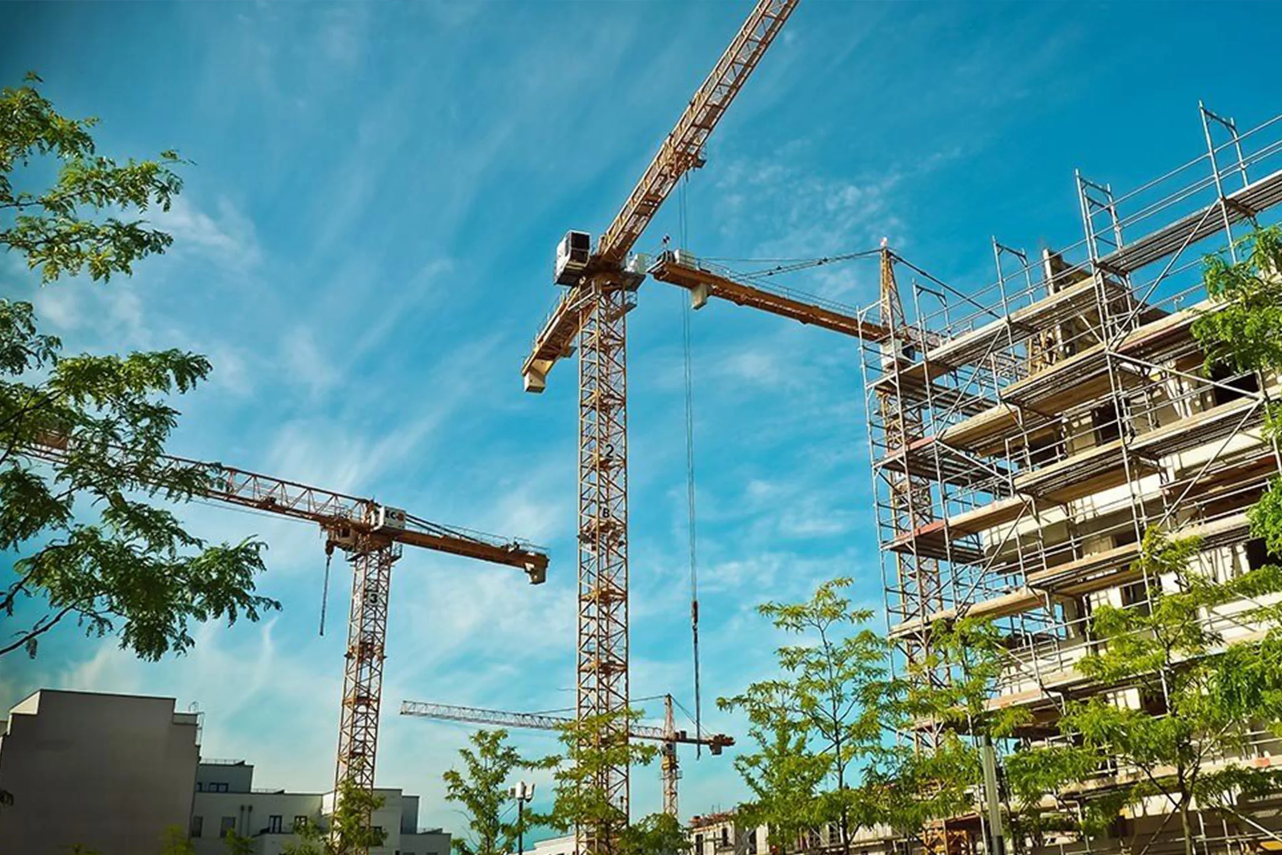 cranes and a building under construction